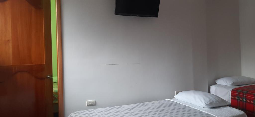 Postel nebo postele na pokoji v ubytování Hostal Miconia