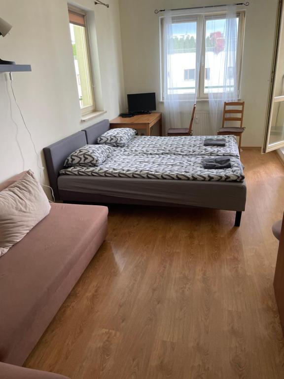 a room with two beds and a couch in it at Pokoje Mokotów in Warsaw