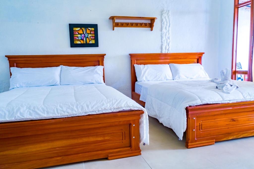 Postel nebo postele na pokoji v ubytování Royal Galápagos Inn