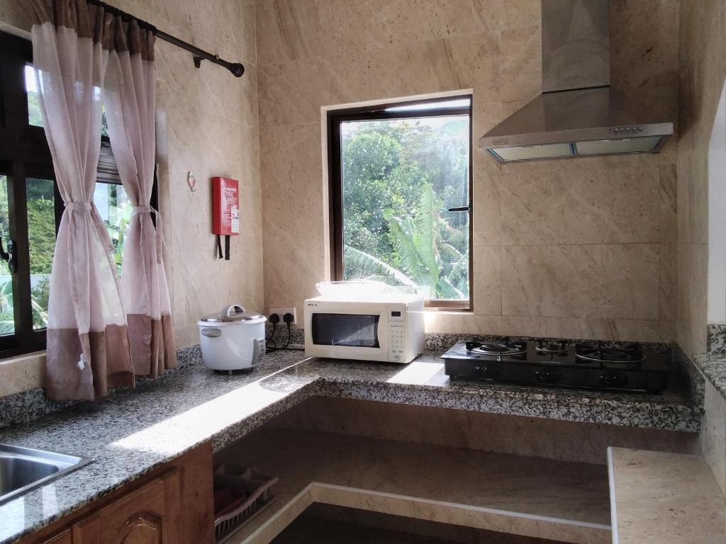 A cozinha ou kitchenette de Belle Rose Vue guest house
