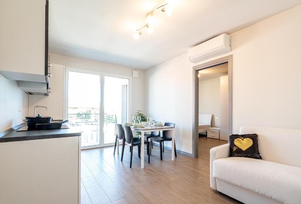 eine Küche und ein Wohnzimmer mit einem Tisch und Stühlen in der Unterkunft Appartamenti Giotto in Sesto al Reghena