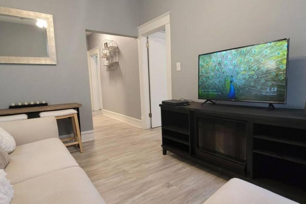 a living room with a large flat screen tv at Retreat Suite 4 - Downtown Getaway in Grand Rapids