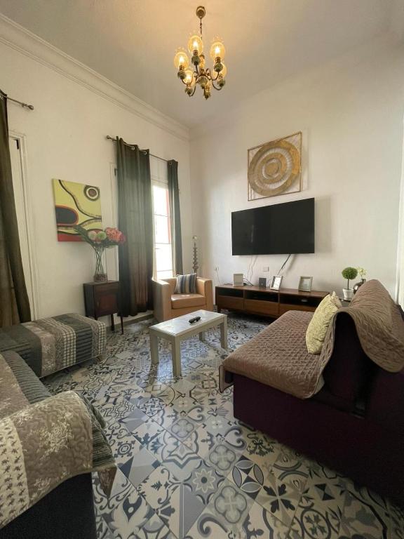 a living room with a couch and a tv at Dream Escape in Santa Cruz de Tenerife