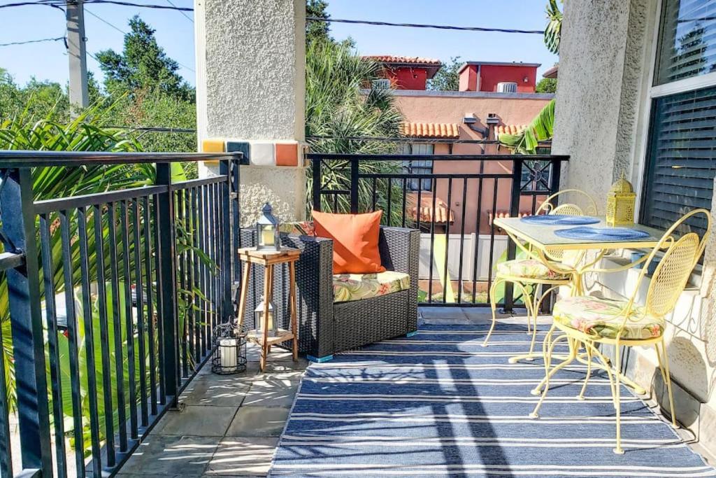 a patio with a table and chairs on a balcony at RETRO RETREAT in DTSP - Explore the downtown area in St. Petersburg