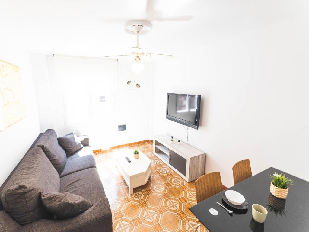 a living room with a couch and a table at Apartamento cerra playa in Gijón