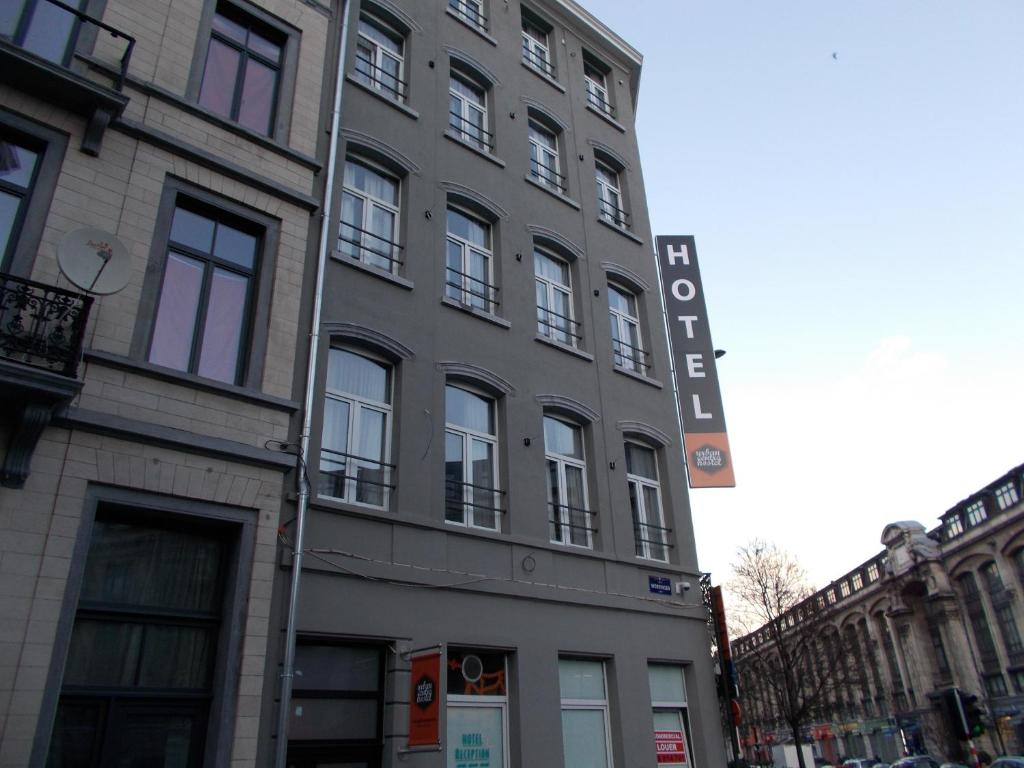 a tall building with a sign on the side of it at Urban City Centre Hostel in Brussels