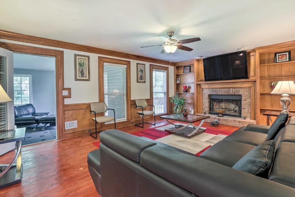 a living room with a couch and a fireplace at Pet-Friendly Lawrenceville House with Deck! in Lawrenceville