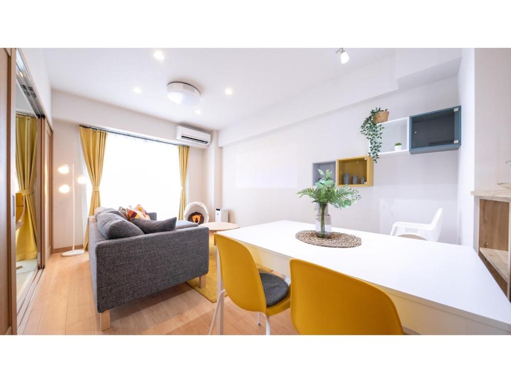 a living room with a table and a couch at Hotel Best Price Kochi - Vacation STAY 17530v in Kochi