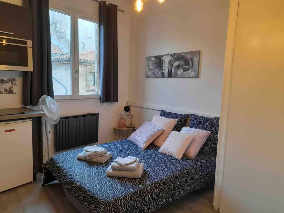 sypialnia z łóżkiem z ręcznikami w obiekcie Très joli studio moderne en plein cœur d’Avignon w Awinionie