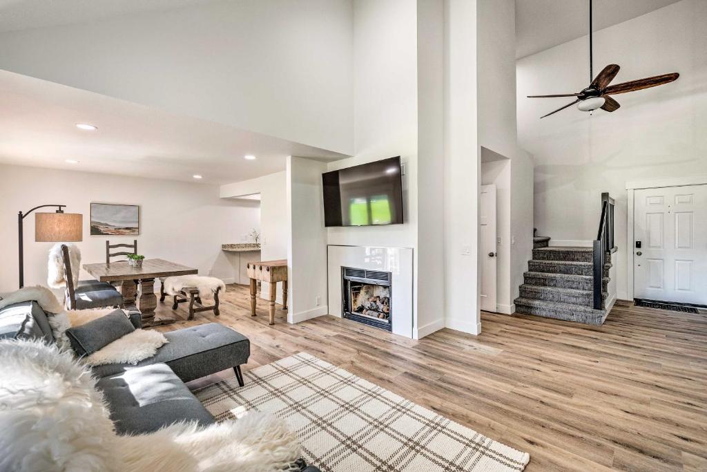 a living room with a couch and a fireplace at Cottonwood Heights Townhome Near Ski Resort! in Cottonwood Heights