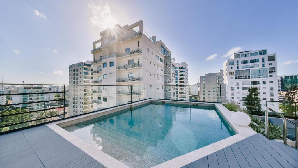 a swimming pool on the balcony of a building at Fully Serviced Apartment at Regatta Living II - 304 in Santo Domingo