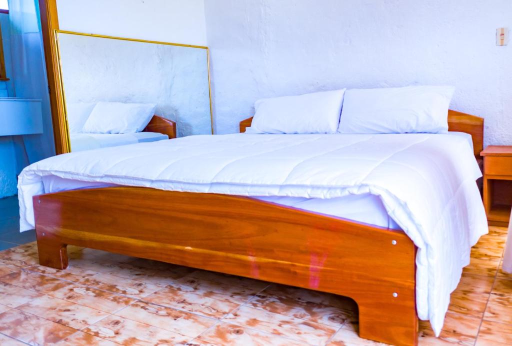 Postel nebo postele na pokoji v ubytování Royal Galápagos Inn
