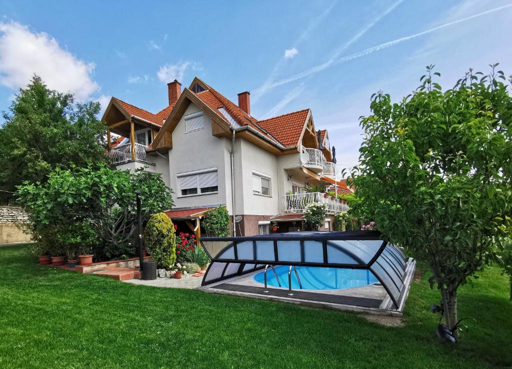 a house with a swimming pool in the yard at Landhaus Forrás in Balatonfüred