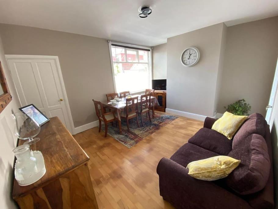 a living room with a couch and a table at Poplar House in Cleethorpes