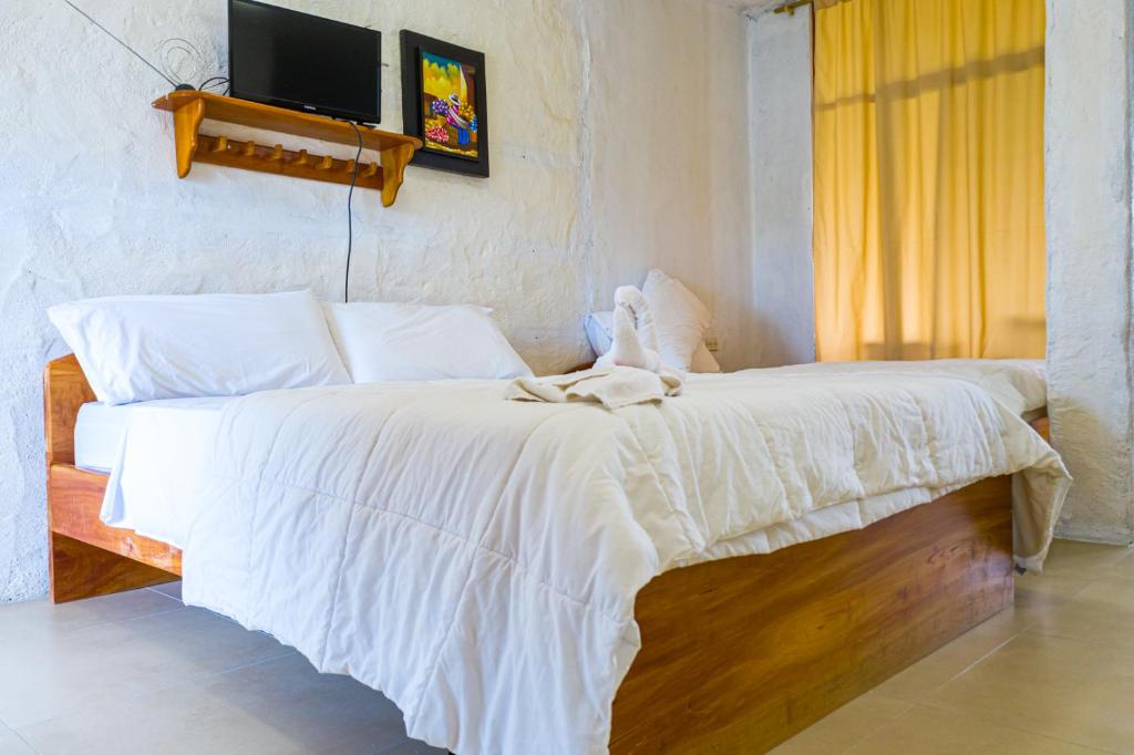 Postel nebo postele na pokoji v ubytování Royal Galápagos Inn