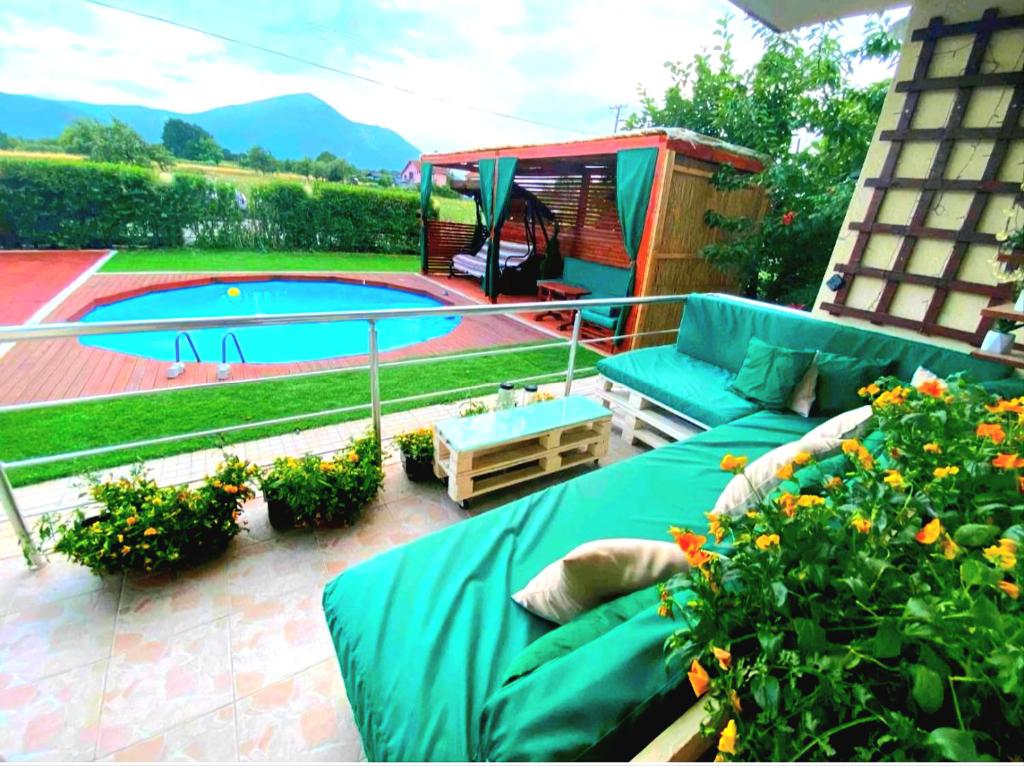 a patio with a couch and a swimming pool at Villa Saturea in Boljevac