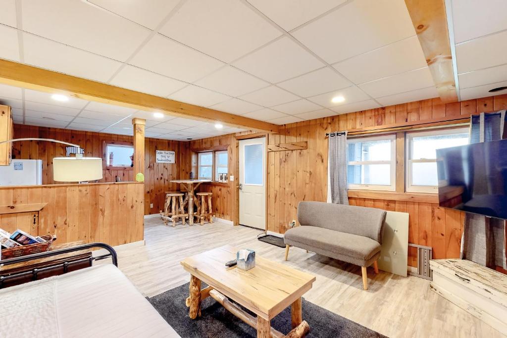 a living room with a couch and a table at Modern Log Chalet - Lower Unit in Montgomery