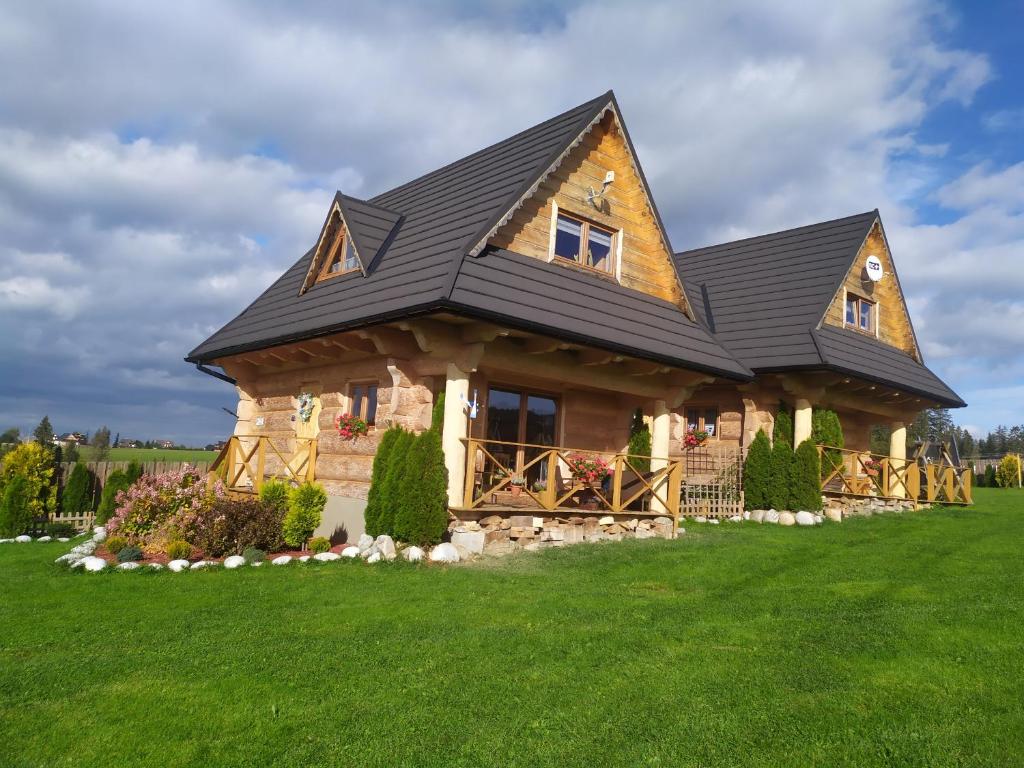 DzianiszにあるOsada Sprzyckaの緑の芝生に葺かれた葺き屋根の家