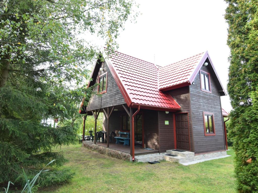 uma pequena casa com um telhado vermelho em holiday home, Zuromino em Żuromino