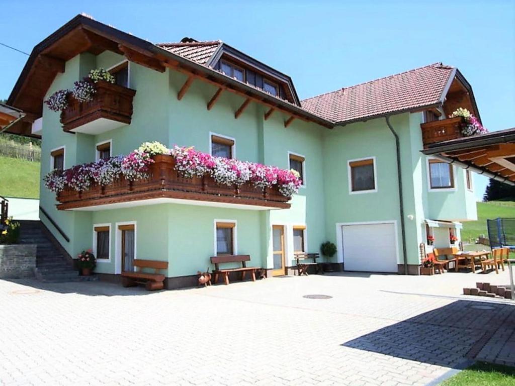 a large house with flowers on the balcony at Sörg Liebenfels in Liebenfels