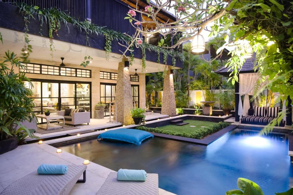 a swimming pool in the middle of a house at Amanputri Villa in Seminyak