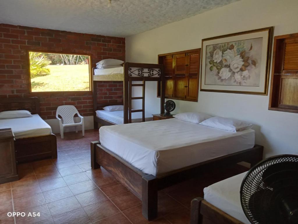 Postel nebo postele na pokoji v ubytování Hostal finca Palermo