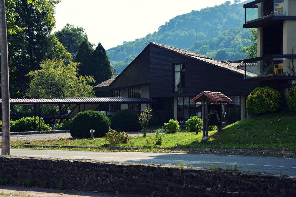 a house on a street in front of a building at Hotel Baztan in Garzáin