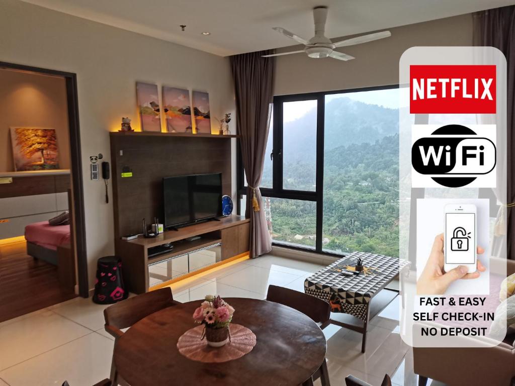 a living room with a table and a tv at Genting Geo 38 Premium Home Plus 6 Nr GPO & Skyway in Genting Highlands