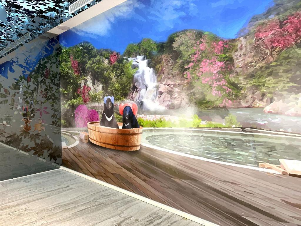 a mural of a waterfall with two dogs in a boat at Uni-Resort Ku-Kuan in Heping