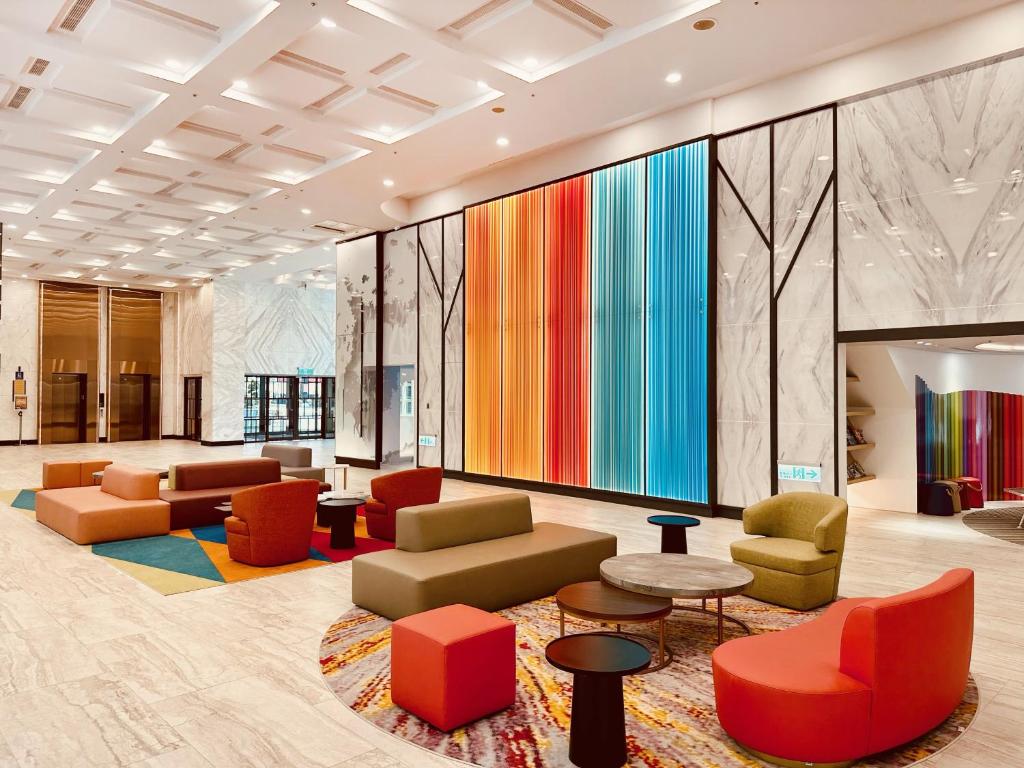 a lobby with colorful furniture and a large mural at Uni-Resort Ku-Kuan in Heping