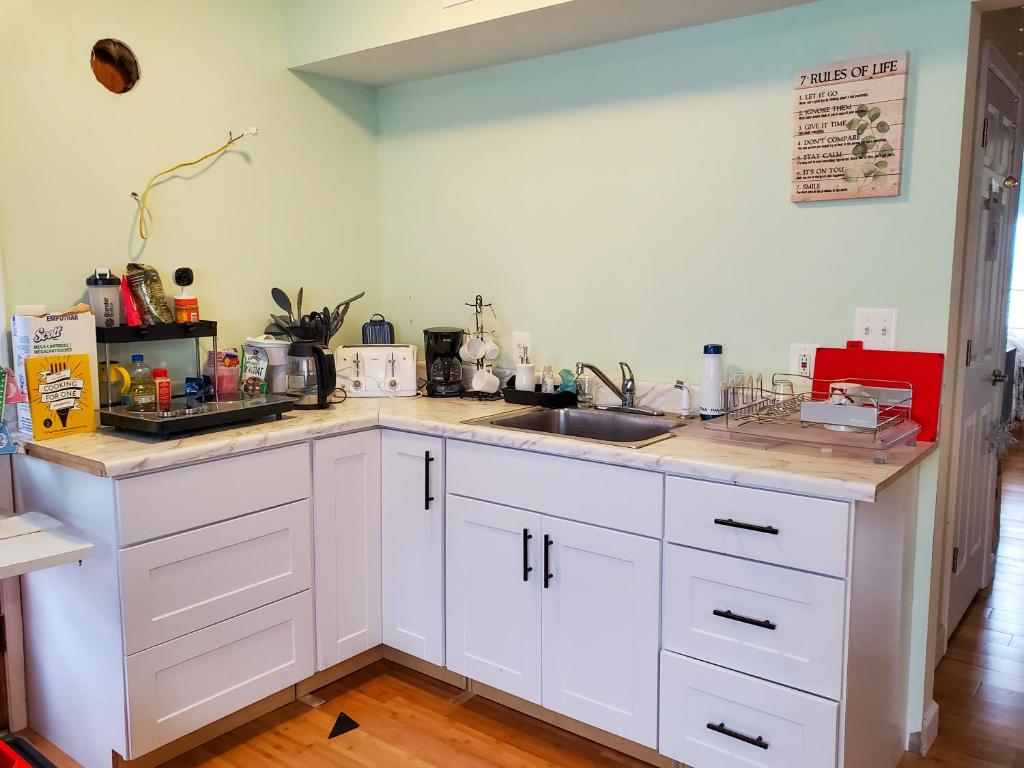 a kitchen with white cabinets and a counter top at 5 star Room2/Close to everything/5 min walk metro/Rockville Town Center in Rockville