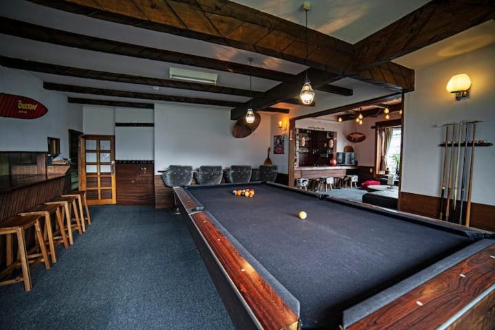 a pool table in a room with a bar at Hai Lodge in Otari