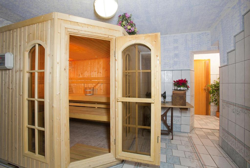 a kitchen with a large wooden cabinet with glass doors at Familienferienhaus Florentine in Längenfeld