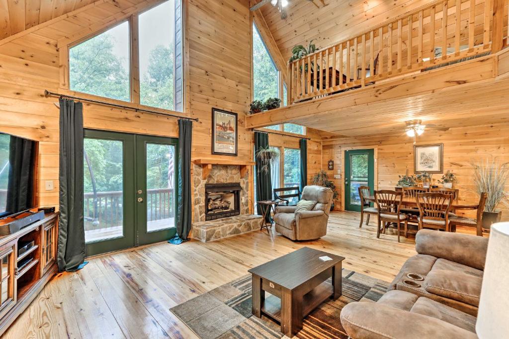 a living room with a fireplace and a dining room at Ellijay Resort Cabin with Deck and Enclosed Porch! in Ellijay