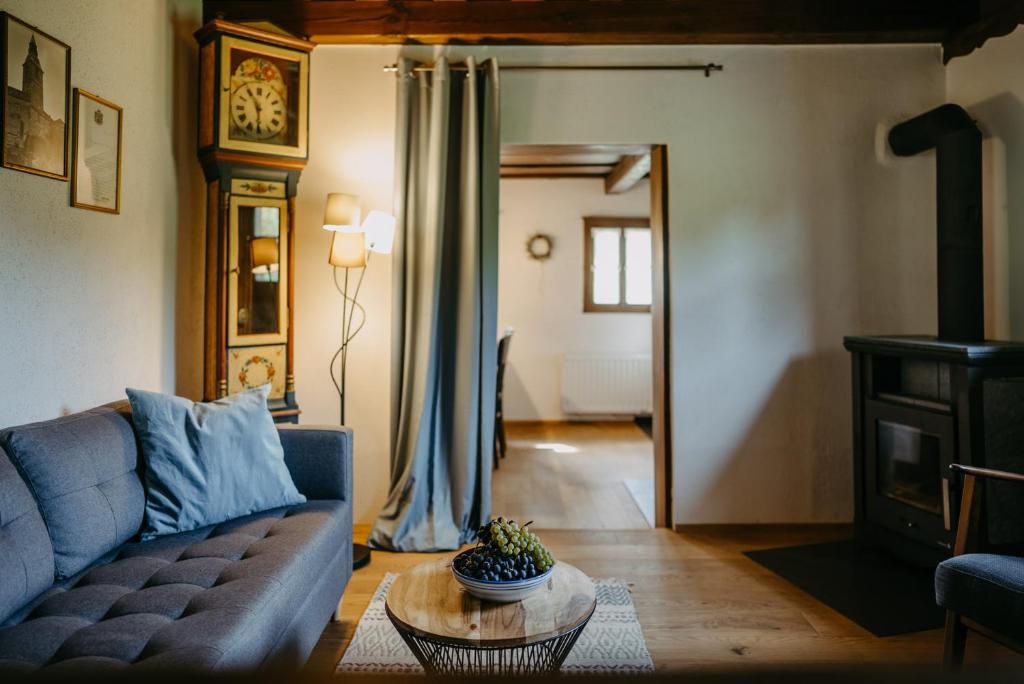 a living room with a blue couch and a table at Kellerstöckl Berg 106 in Strem