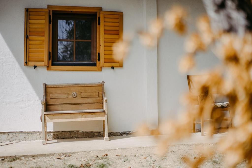 a wooden bench sitting in front of a window at Kellerstöckl Berg 106 in Strem