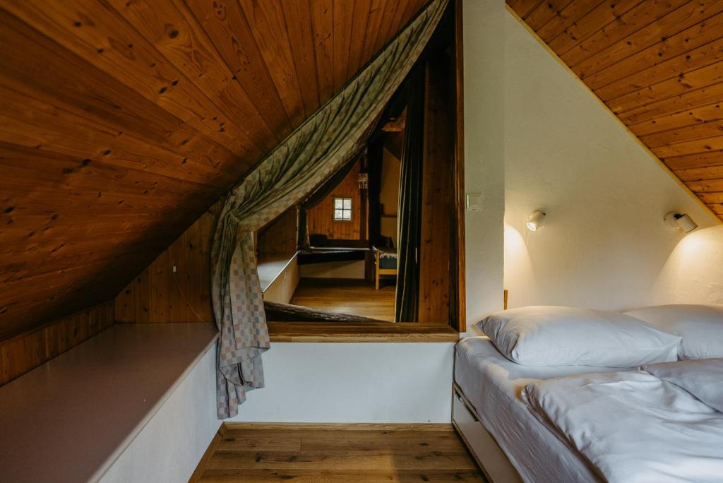 a bedroom with two beds and a large window at Kellerstöckl Berg 106 in Strem