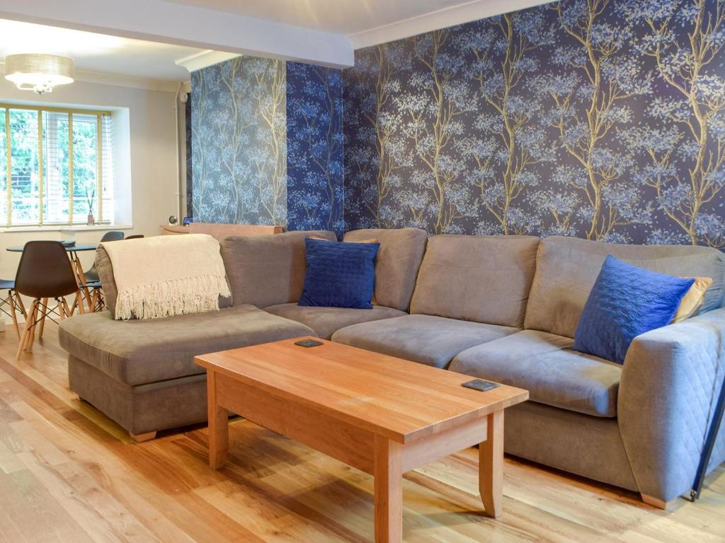 a living room with a couch and a table at Castle Street Cottage in Narberth