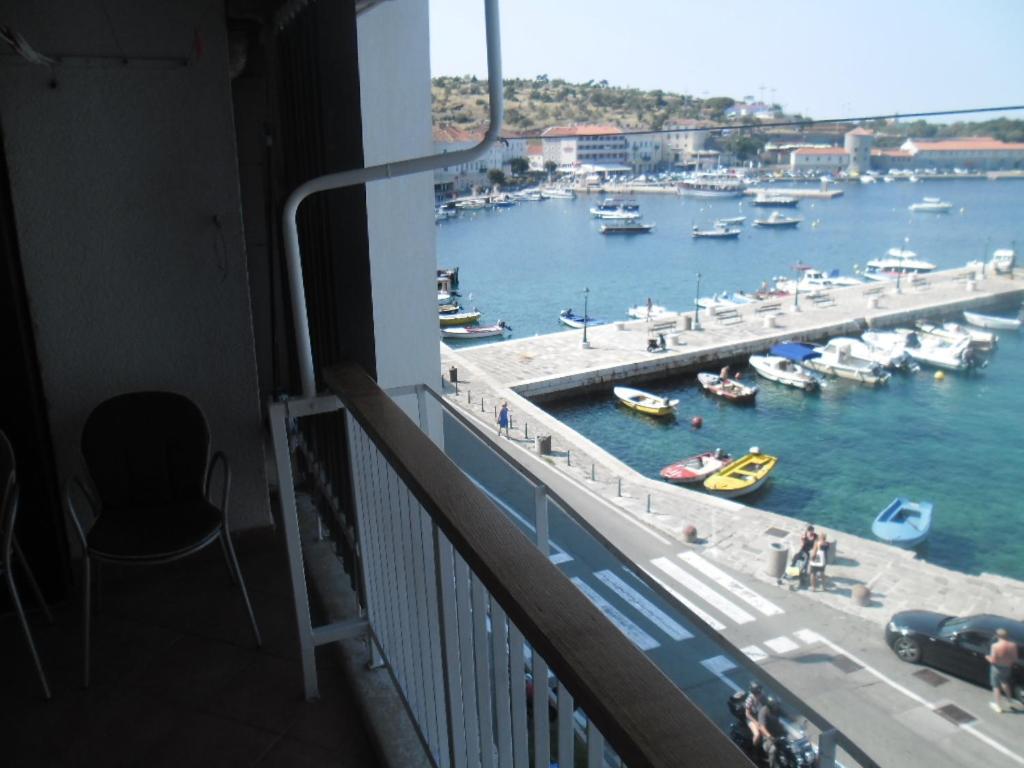 a balcony with a view of a harbor with boats at Apartment Riva in Senj