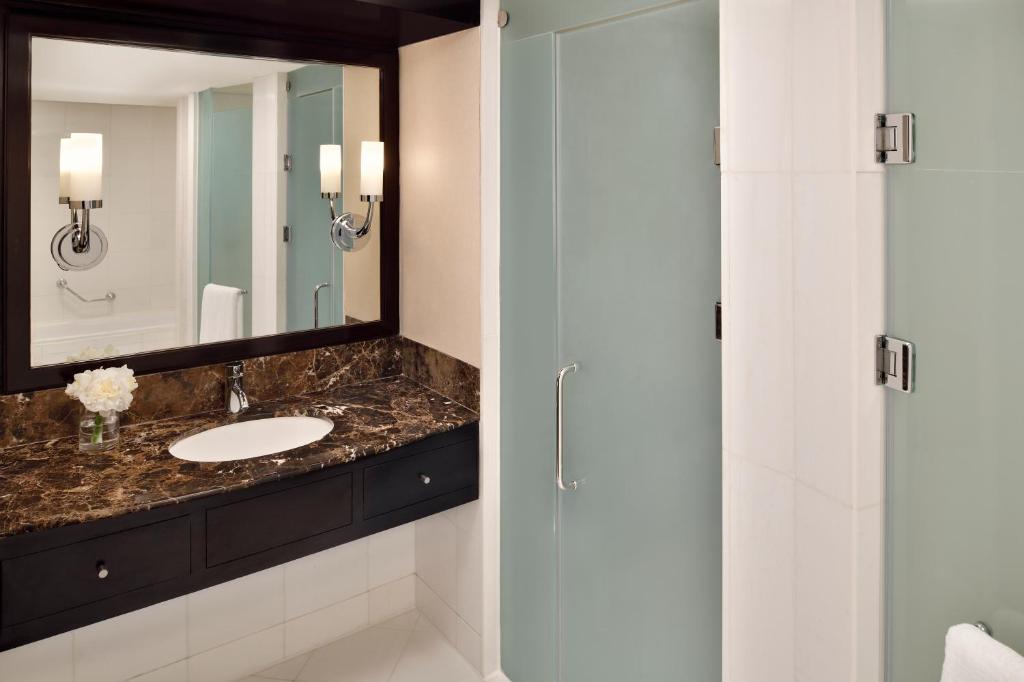 a bathroom with a sink and a shower at InterContinental Abu Dhabi by IHG in Abu Dhabi