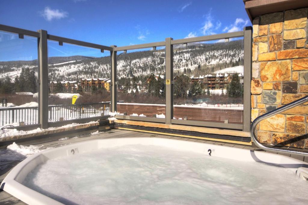 a hot tub on a balcony with a mountain view at Slopeside in Keystone
