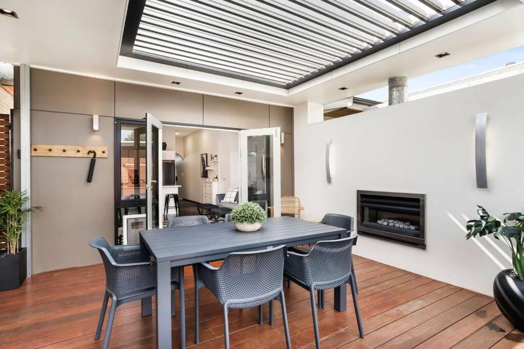 a dining room with a table and chairs at Cute as a Button - Picket Fence 3 Bed Stylish Home in Unley