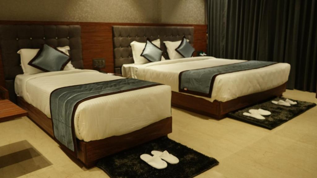 Postel nebo postele na pokoji v ubytování Alaukik Hotel
