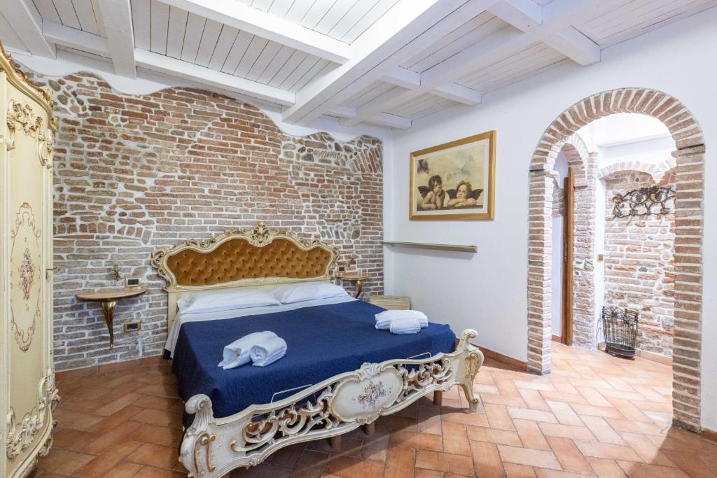 a bedroom with a bed in a brick wall at De'Gombruti, Bologna by Short Holidays in Bologna