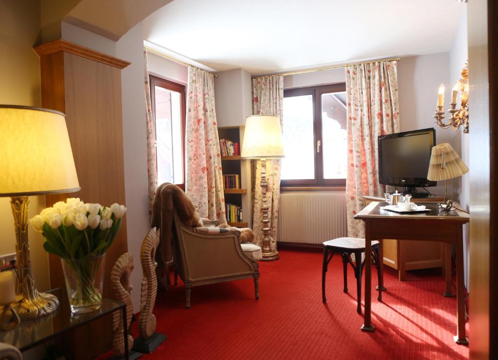 a girl sitting in a chair in a living room at Kristiania Lech in Lech am Arlberg