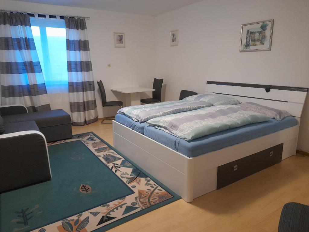 a bedroom with a bed and a living room at Appartment für 4 bis 8 Personen in Bad Zell