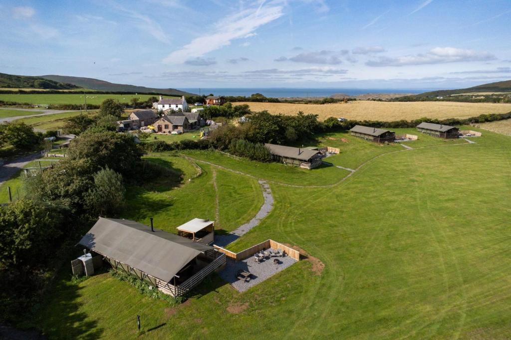 an aerial view of a house in a field at Worms Head - Safari Tent - Llangennith in Llangennith