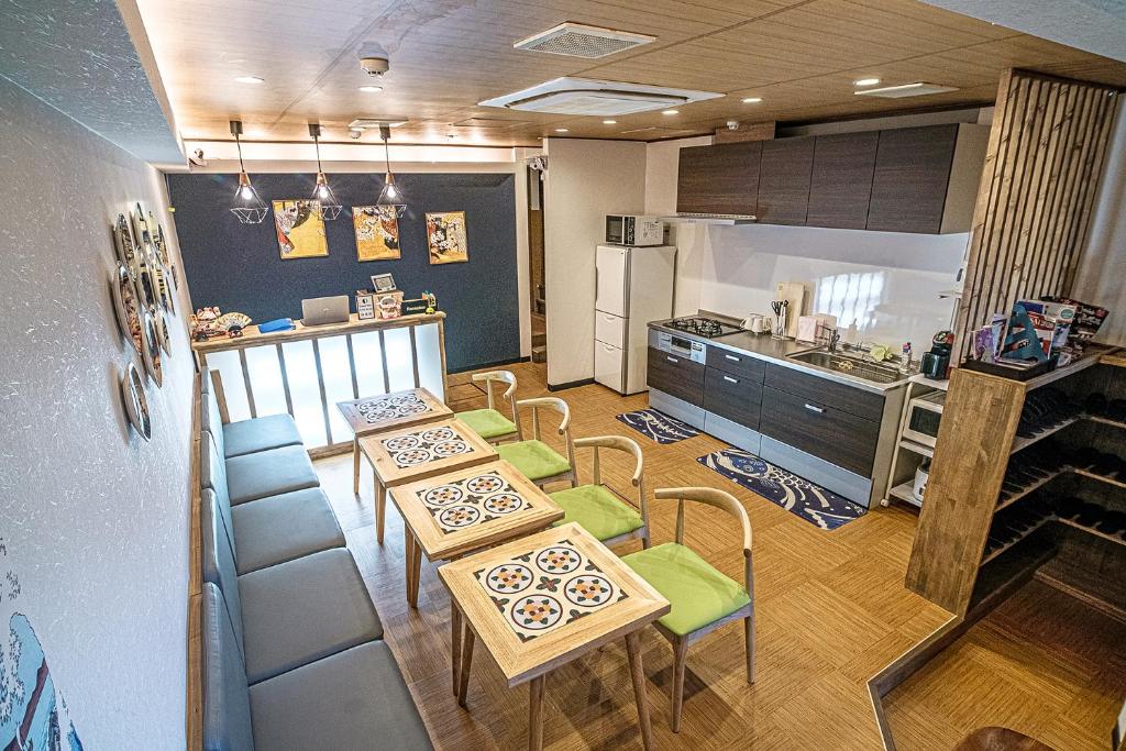 a kitchen with two tables and chairs and a kitchen with a counter at 久宿　白川 in Kyoto