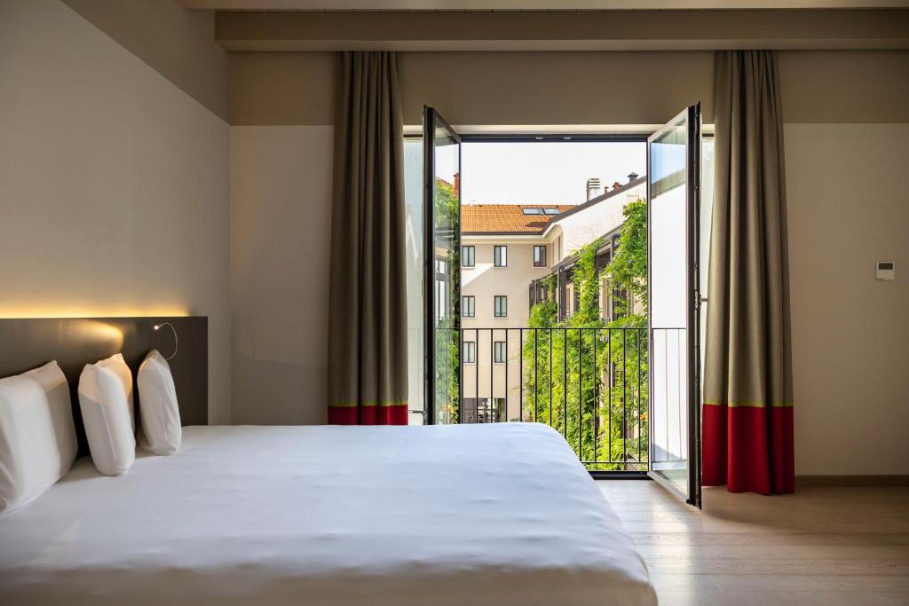 Postel nebo postele na pokoji v ubytování Savona 18 Suites