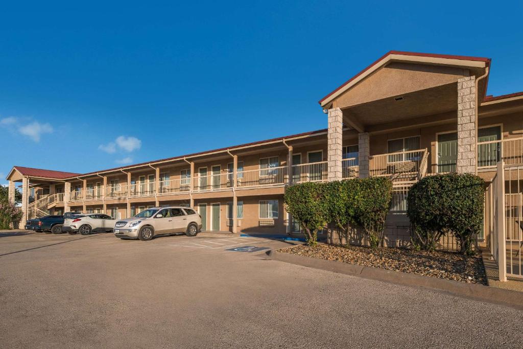 a building with cars parked in a parking lot at Quality Inn in Sonora